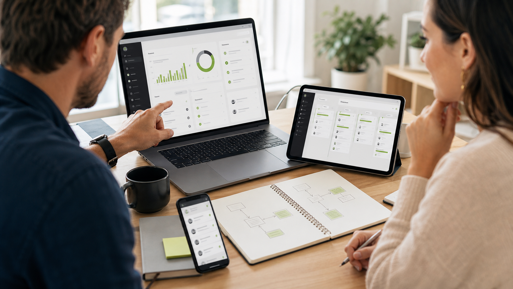 Consultant and business owner reviewing connected software dashboards across laptop, tablet, and phone